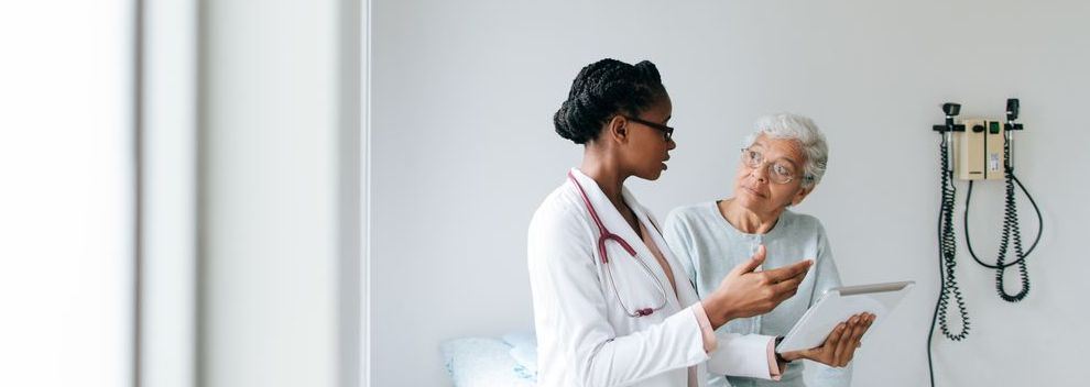 Doctor talking with elderly patient